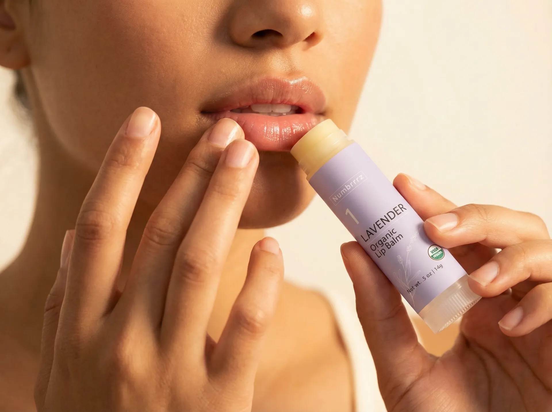 Woman applying Numbrrrz organic lavender lip balm