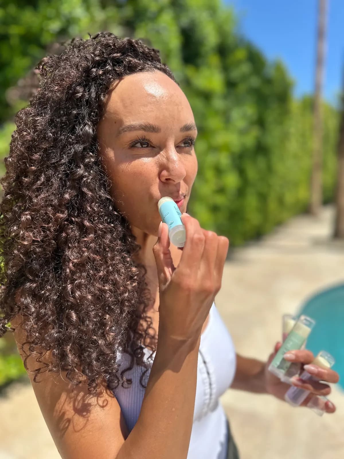 Numbrrrz founder applying organic lip balm